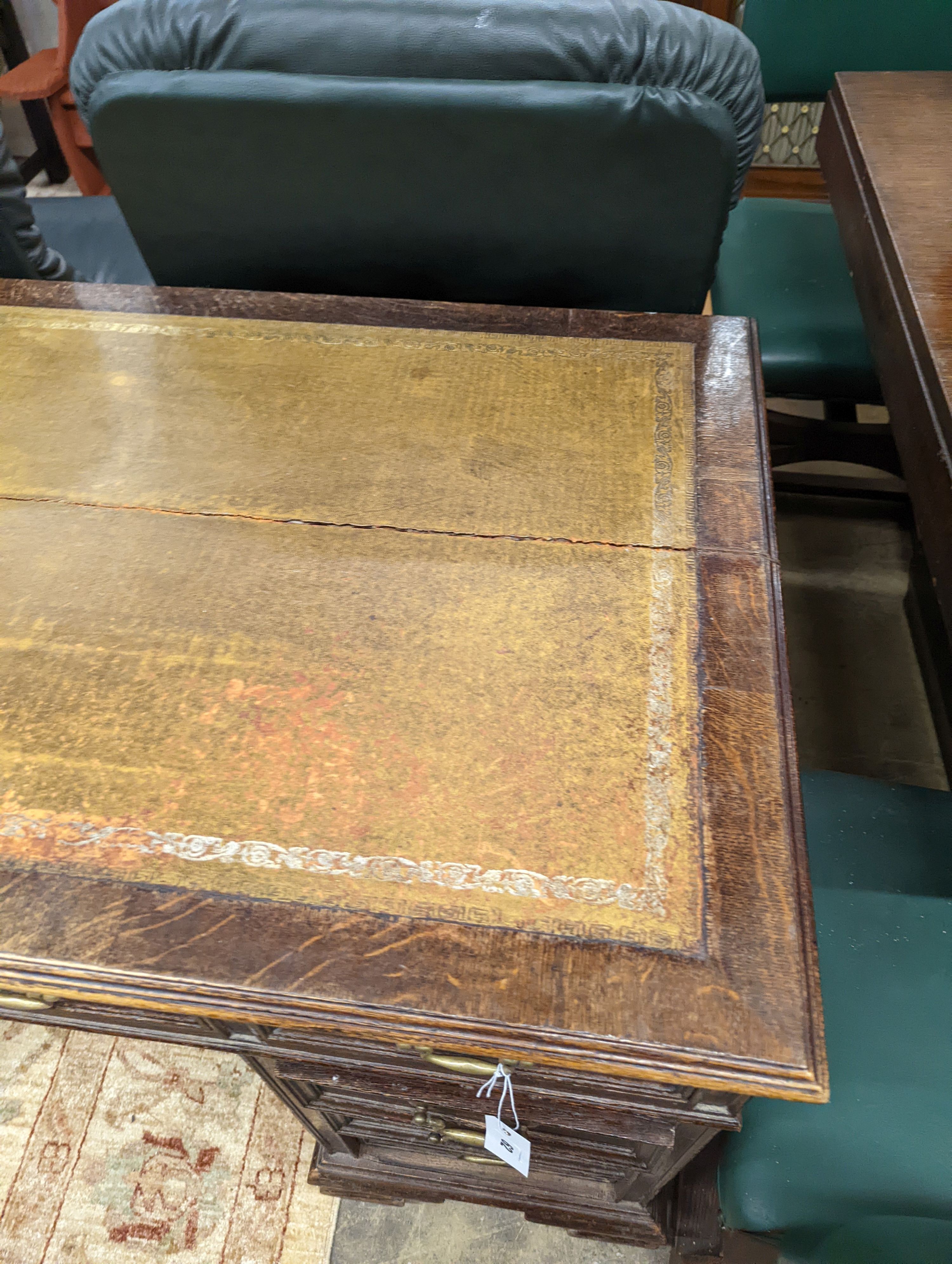 An early 20th century oak kneehole desk, length 122cm, depth 66cm, height 75cm